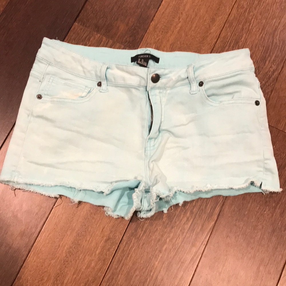 Forever 21 light teal ripped jean shorts.